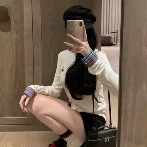 white long sleeve tshirt with plaid cuff and little Saturn embroidery